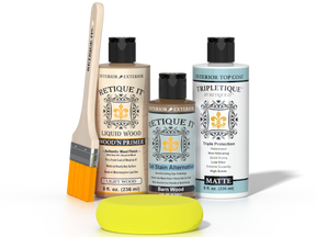Retique It® Barn Wood kit with brush, Wood’n Primer, Barn Wood stain alternative, matte top coat, and yellow sponge on a black background.