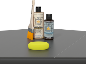 Retique It® Charcoal Brush-On Kit includes a brush, Light Wood primer, Charcoal Gel Stain Alternative, and a yellow sponge.