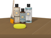 Retique It® Light Wood kit with brush, Wood’n Primer, Pecan stain alternative, and yellow sponge on a wood surface.