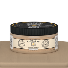 Retique It® Liquid Wood 8oz light interior paint jar on table, showcasing natural wood finish and smooth paint texture.