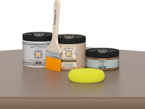 Retique It Barn Wood Kit with Satin Polytique It, Light Wood Wood'n Primer, Barn Wood Gel Stain Alternative, paintbrush, and yellow sponge on a tabletop.