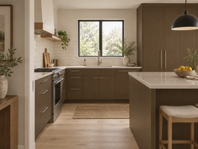 Briarsmoke kitchen cabinets and island with pale countertops, a white tile backsplash, and stainless steel appliances.