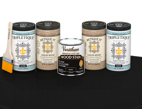 64 oz Retique It Liquid Wood kit with Ebony stain, gloss Tripletique topcoat, and a paintbrush on a matching finished tabletop.