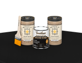Retique It multi-purpose kit with two large ebony oil-based fast-dry stains displayed on a table.
