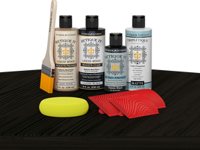 Retique It® Classic Black Wood'n Kit with Light Wood primer, Classic Black stain, Classic Black gel stain alternative, Matte Tripletique® Top Coat, brush, red graining tool, and yellow sponge.