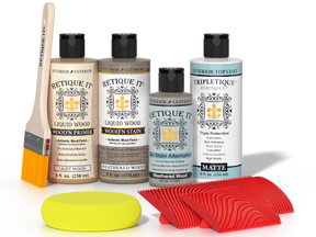 Retique It® Weathered Wood Wood'n Kit with Light Wood primer, Weathered Wood stain, Weathered Wood gel stain alternative, Matte Tripletique® Top Coat, brush, red graining tool, and yellow sponge.