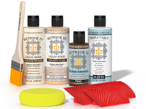 Retique It® White Oak Wood'n Kit with Bleached Wood Primer, Pickled Oak Wood'n Stain, Matte TripleTique Top Coat, Pecan Gel Stain Alternative, yellow sponge, red graining tool, and brush.