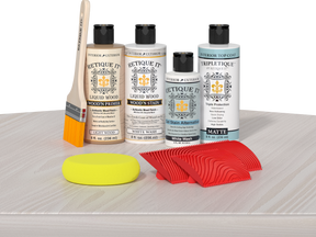 Retique It® White Wash Wood'n Kit with Light Wood primer, White Wash stain, White Wash gel stain alternative, Matte Tripletique® Top Coat, brush, red graining tool, and yellow sponge.