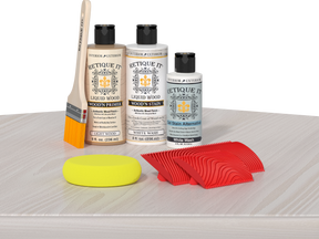 Retique It® Fireplace Mantel Wood'n Finish Kit in White Wash stain displayed on a table with finished wood texture and color.