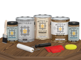 Retique It® Wood'n Finish Kit in Dark Oak with matte top coat, includes four large exterior wood finish products, displayed on a table.