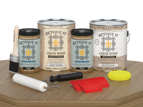 Retique It® Wood'n Kit in Pickled Oak for wood finishing, showing four large finish bottles on a woodworking table.