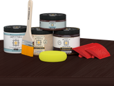 Retique It® Wood'n Finish Kit in Red Mahogany stain, double size, with stain bottles and applicator on table surface.
