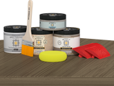 Retique It Weathered Wood Wood'n Finish Front Door Kit stain displayed on a table, showcasing natural weathered wood appearance.