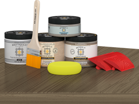 Retique It Wood'n Finish Front Door Kit in Weathered Wood stain, featuring stain bottles and finishing tools on a table.