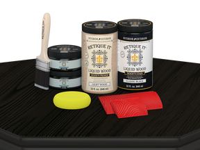 Retique It Wood'n Cabinet Kit in classic black with 12 grained door stains, displayed on a table for cabinet renovation.
