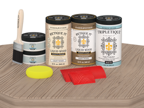 Retique It Wood'n Finish Kit with four large French Oak stain bottles for tabletop furniture, matte finish on a wooden surface.