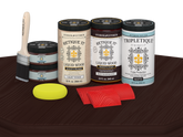 Retique It® Wood'n Finish Kit with four large red mahogany stain bottles and matte finish on a tabletop surface.