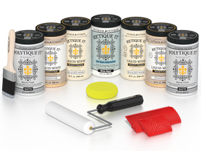 Retique It® Sun Bleached finishing system with PolyTique It® Matte top coat, featuring Liquid Wood Wood’n Primer in Bleached Wood, Liquid Wood Wood’n Stain in Pickled Oak, White Wash Gel Stain Alternative, paintbrush, roller, yellow sponge, red graining tools, and protective matte finish products for creating a weathered sun-bleached wood look.