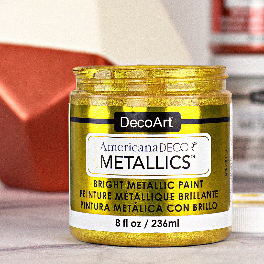 DecoArt Americana Decor Metallics pearl finish in an 8 oz bottle, showcasing shiny, metallic paint ideal for craft and home decor projects.